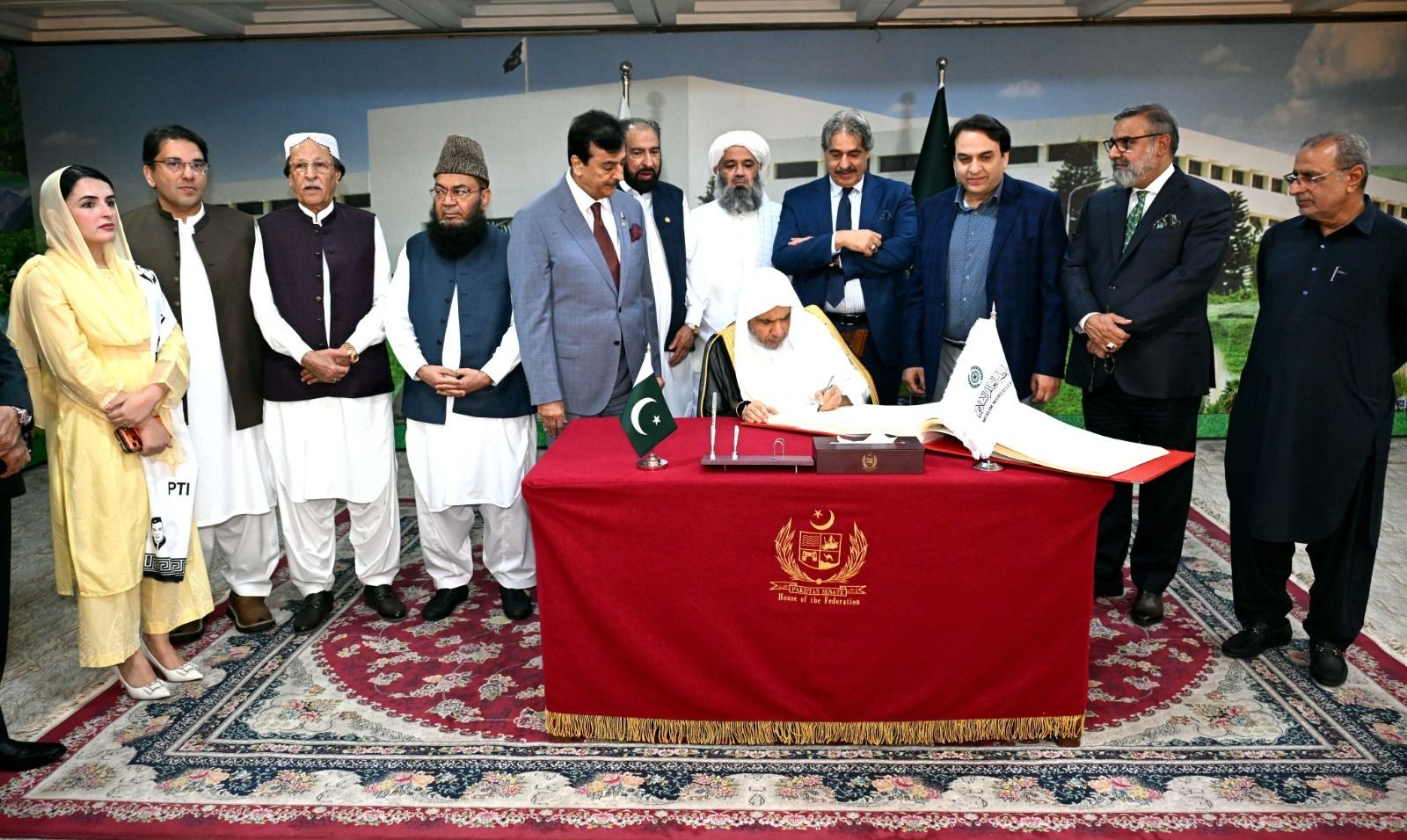 H.E. Dr. Mohammad bin Abdulkarim Al-Issa, Secretary-General of the Muslim World League (MWL) recording his comments on visitors book placed at Senate of Pakistan, Parliament House Islamabad