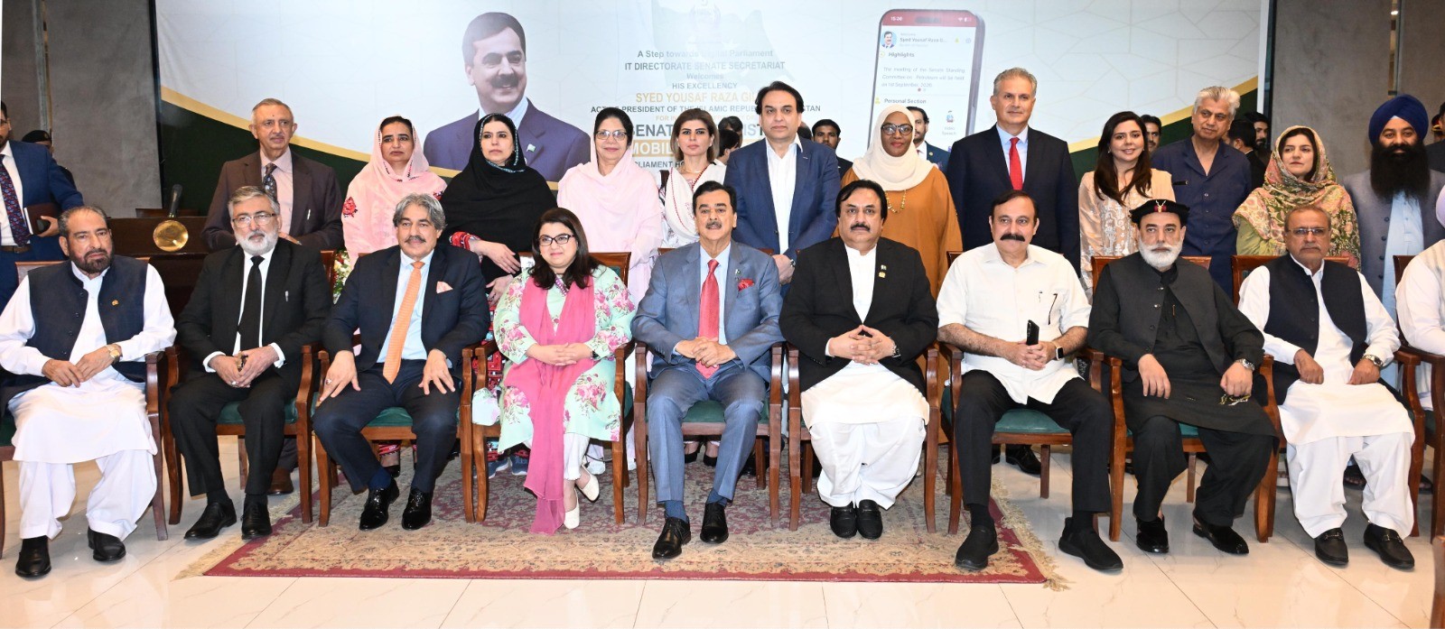 Acting President, Syed Yousaf Raza Gilani in a group photo at the inaugural ceremony of the Senate of Pakistan mobile application at Parliament House, Islamabad