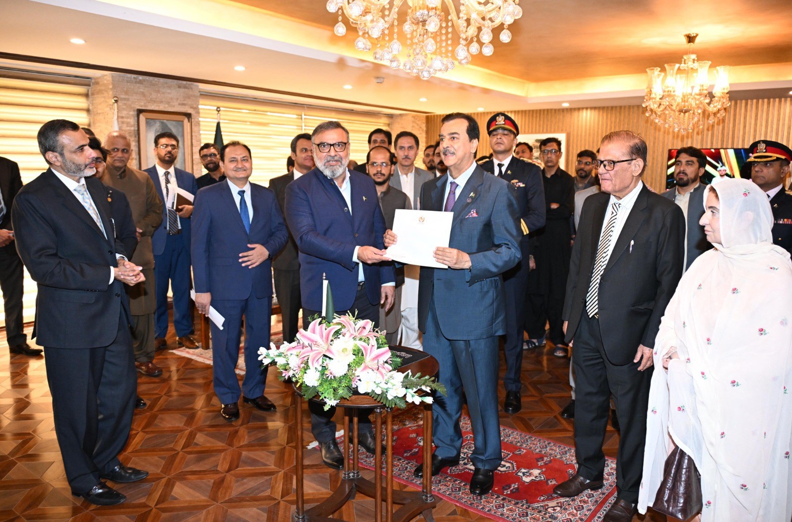 Senator Amir Waliuddin Chishti presenting to Chairman Senate, Syed Yousaf Raza Gilani a donation of Rs. 1 million to the Senate Employees Welfare Fund for the welfare and well-being of Senate employees at Parliament House, Islamabad.